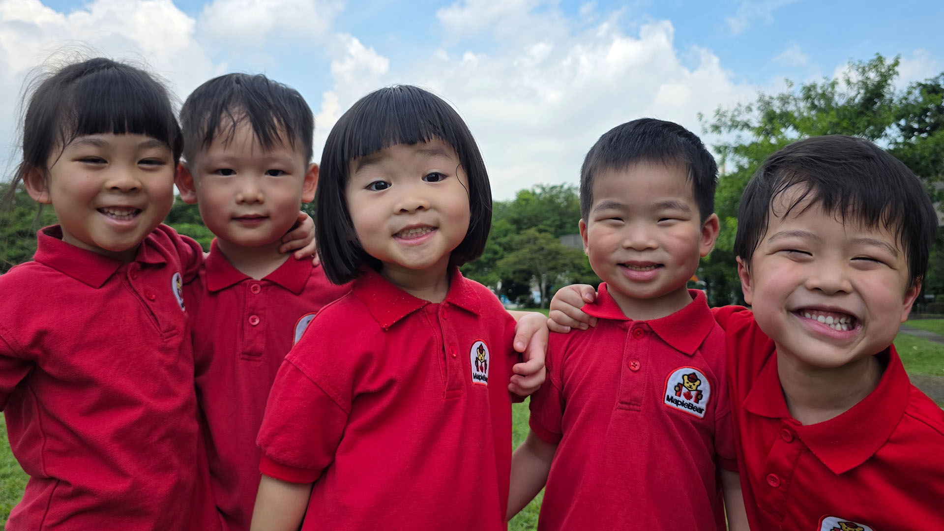 Happy children in MapleBear uniforms at our Jurong Gateway centre